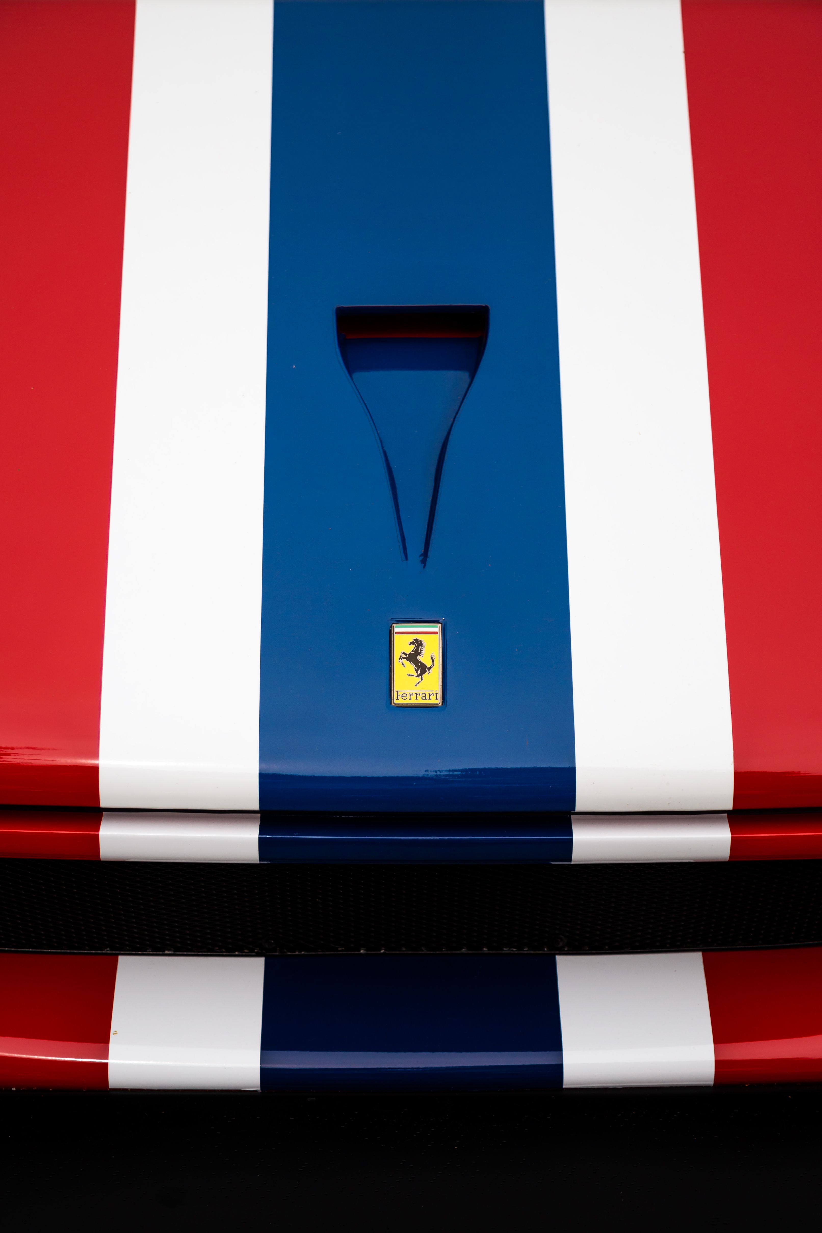 Red Ferrari F40 front close up showing the racing stripe and low nose